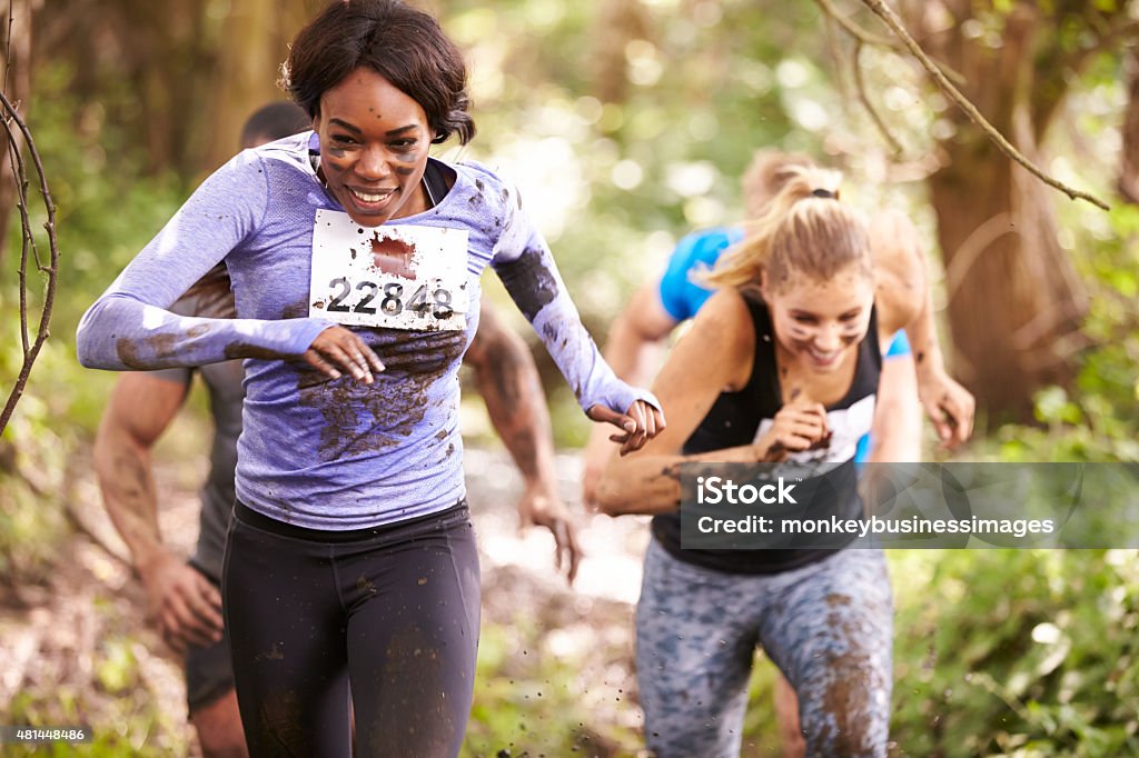 Two women running in a forest at an endurance event Two women enjoying a run in a forest at an endurance event Obstacle Course Stock Photo