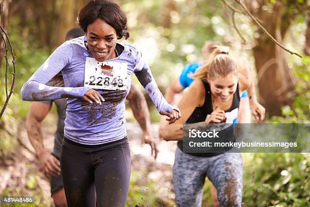 Two Women Running In A Forest At An Endurance Event Stock Photo - Download Image Now