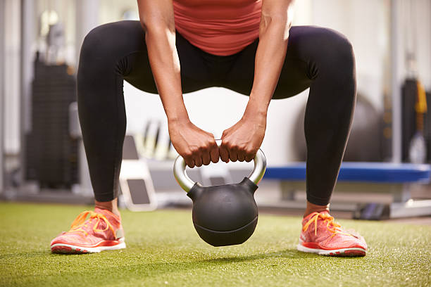 istock Woman exercising with a kettlebell weight, 481448636