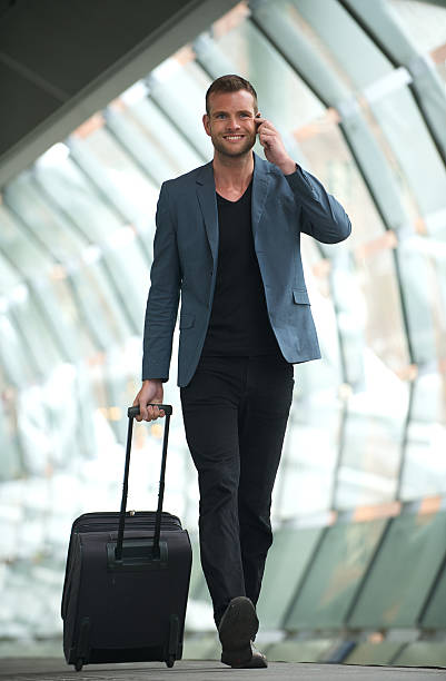 istock Young businessman walking with travel bag 481448757