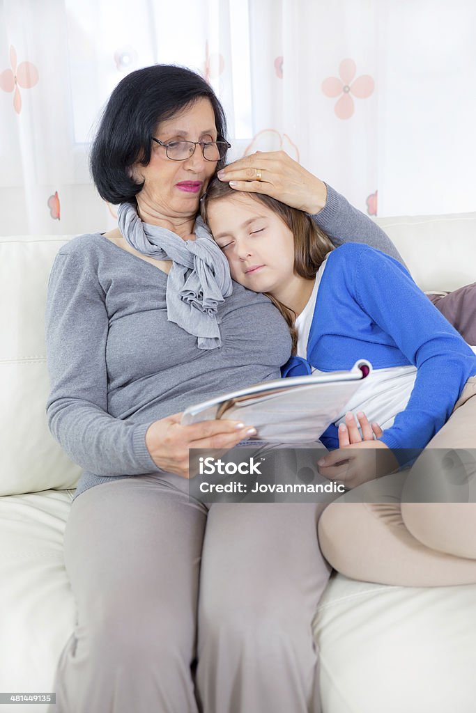 Grandmother and granddaughter with magazine 60-69 Years Stock Photo
