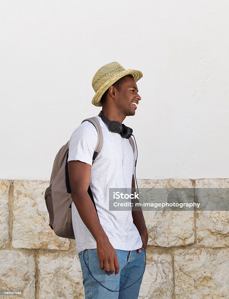 Happy young guy outdoors with hat and bag Portrait of a happy young guy outdoors with hat and bag 20-29 Years Stock Photo