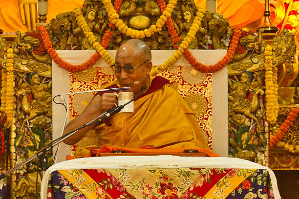 The Dalai Lama teaching in Dharamsala, India Dharamsala, India - September 24, 2014: The Dalai Lama gives his bi-annual teachings at the Dalai Lama Temple, Mcleod Ganj, Dharamsala, India dalai lama stock pictures, royalty-free photos & images