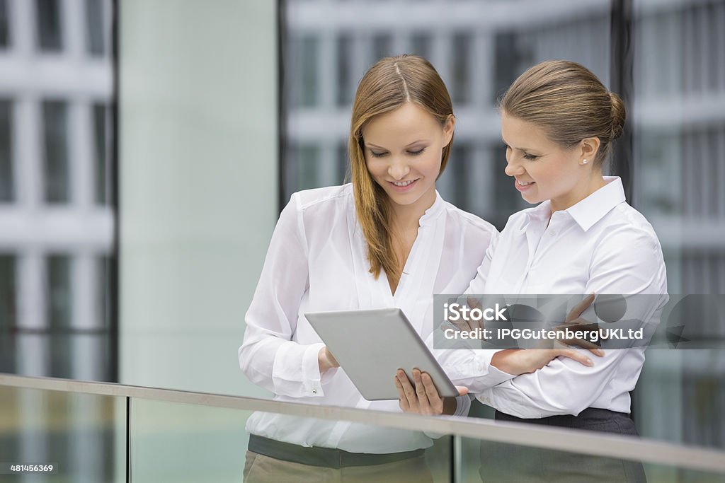 Businesswomen using digital tablet in office 18-19 Years Stock Photo