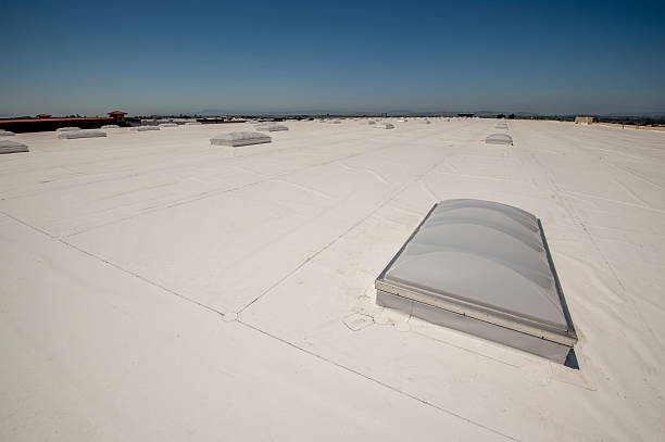 PVC Membrane Roof on a Large Warehouse PVC roof with skylights on a very large warehouse building. pvc stock pictures, royalty-free photos & images