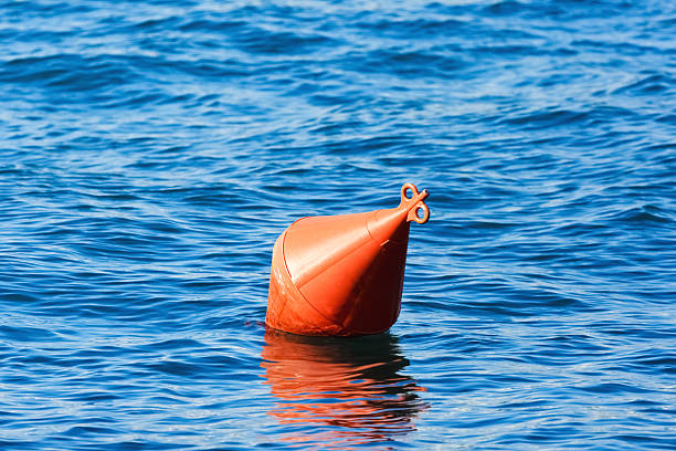 оранжевый buoy на голубой воде - buoy anchored sea wave стоковые фото и изображения