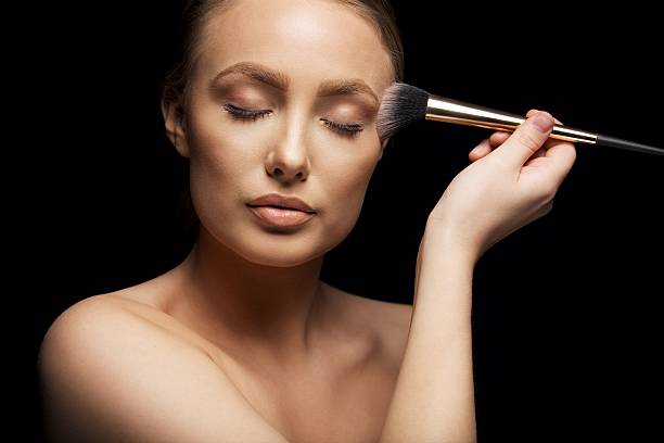 istock Beautiful woman putting make up on 481462787