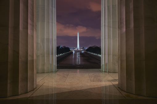 Night scene of Wahington DC. View of Washington Monument from inside of the Lincoln Memorial.