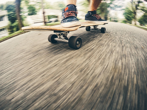 Motion blur of skateboarder going downhill