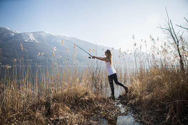 istock Young woman fishing 481466243