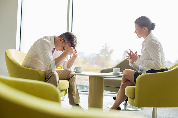 istock Businesspeople in serious discussion at office lobby 481467237