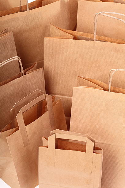 istock Shopping brown gift bags background 481469871