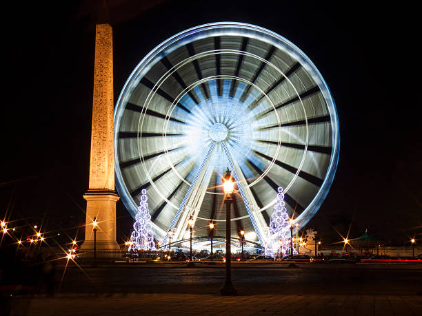 istock Obelisk and Ferris Wheel in motion at Christmas. night shot 481470233