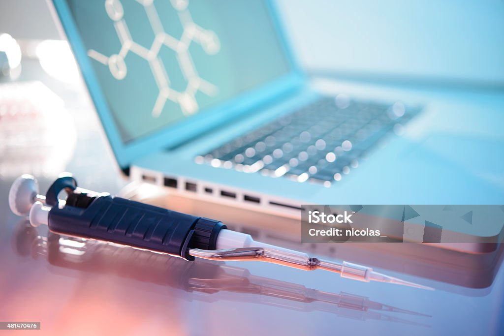 Laboratory Equipment A pipette next to a laptop 2015 Stock Photo