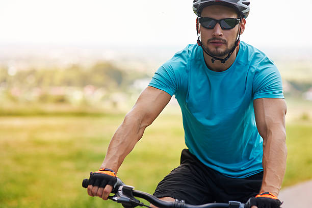 istock Well built man riding a bike 481475028