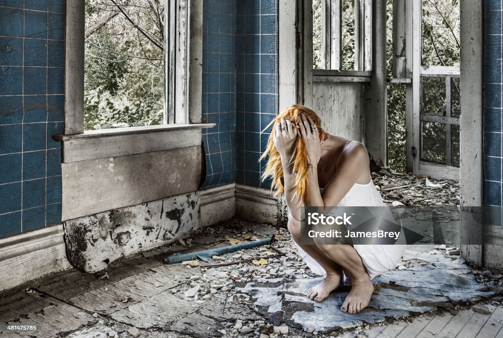 Sad Woman Crouching, Sobbing Amid Ruins Begging - Social Issue Stock Photo