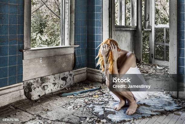 Sad Woman Crouching Sobbing Amid Ruins Stock Photo - Download Image Now - Begging - Social Issue, Teenager, Accidents and Disasters