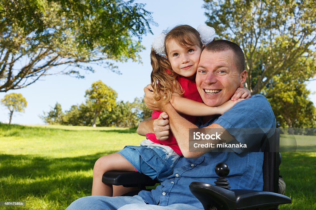 Disabled dad play with daughter Disabled father with his little daughter Wheelchair Stock Photo