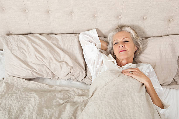 istock Senior woman sleeping in bed 481476025