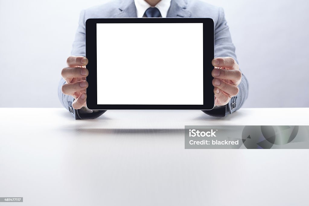 Businessman Showing Digital Tablet Front view of a businessman showing a blank screen digital tablet. 30-39 Years Stock Photo