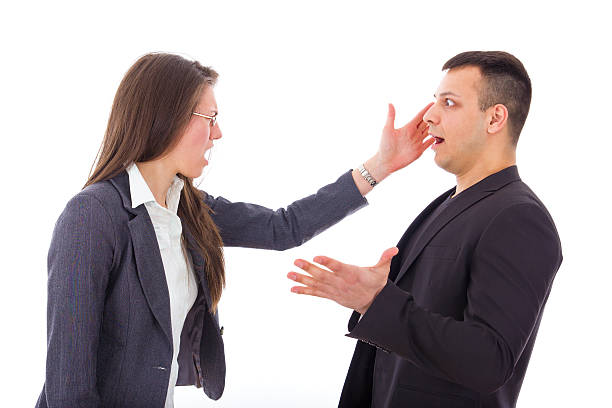 business woman slapping man's face stock photo