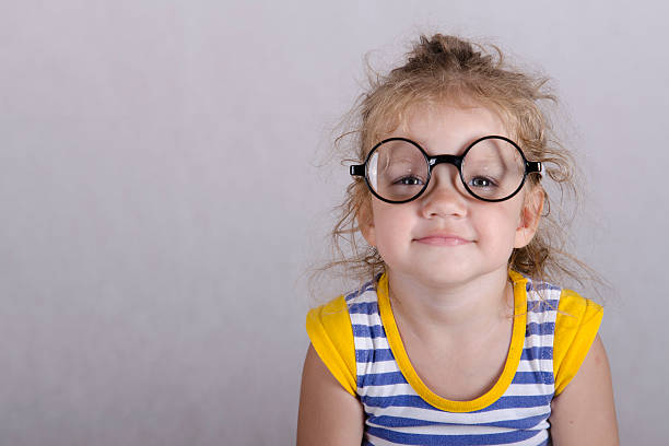 istock Two-year-old girl funny glasses sitting looking in frame 481477515