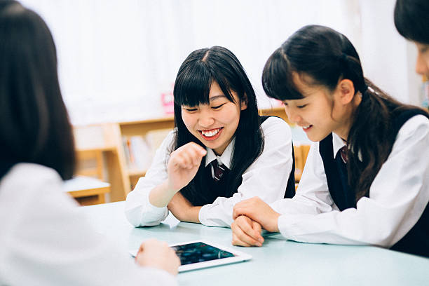 istock Japanese female students playing a fun digital tablet game 481479102