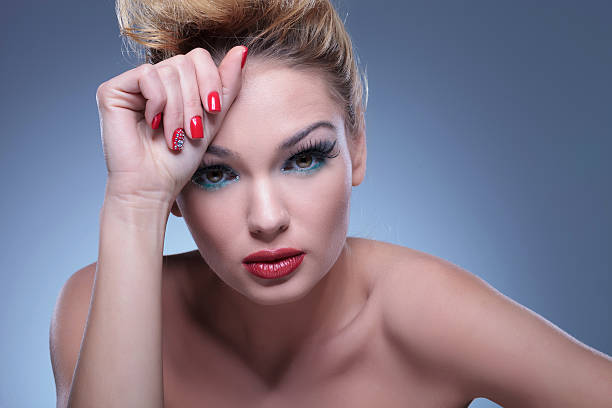 istock relaxed beauty woman wearing makeup and red nails 481480667