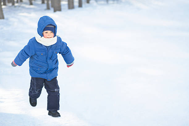 istock Boy In Hooded Jacket Walking Snow 481482097