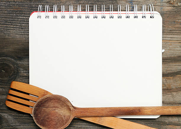 blank recipe book on wooden table - yemek kitapları stok fotoğraflar ve resimler