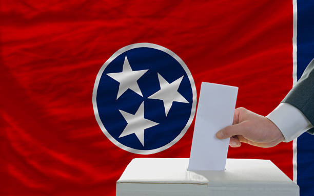 istock man voting on elections in front  flag of tennesee 481483859
