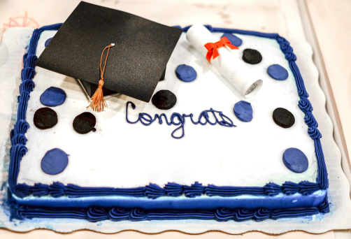 Graduation cake with a blank section for names.