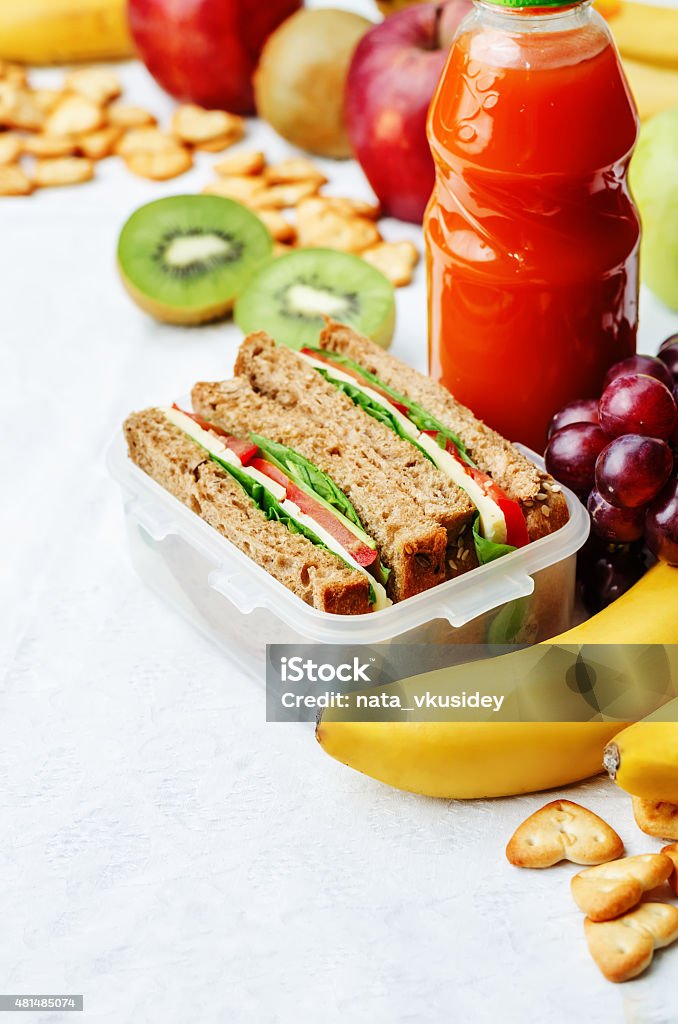 school lunch with a sandwich, fresh fruits, crackers and juice school lunch with a sandwich, fresh fruits, crackers and juice. the toning. selective focus 2015 Stock Photo