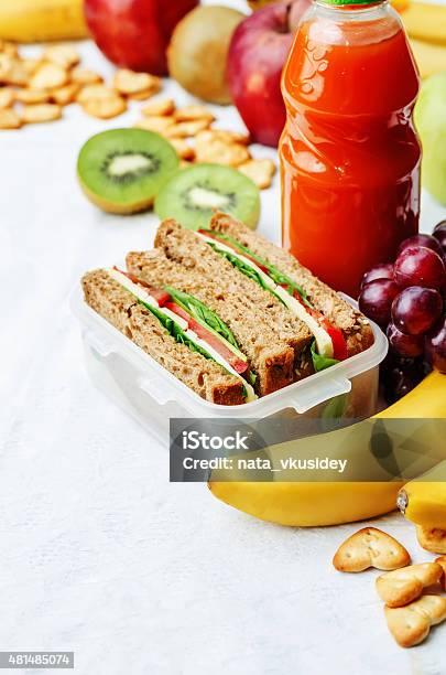School Lunch With A Sandwich Fresh Fruits Crackers And Juice Stock Photo - Download Image Now