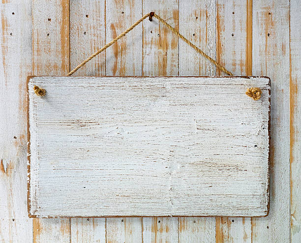 istock Old weathered white wood signboard hanging from an old nail. 481485568