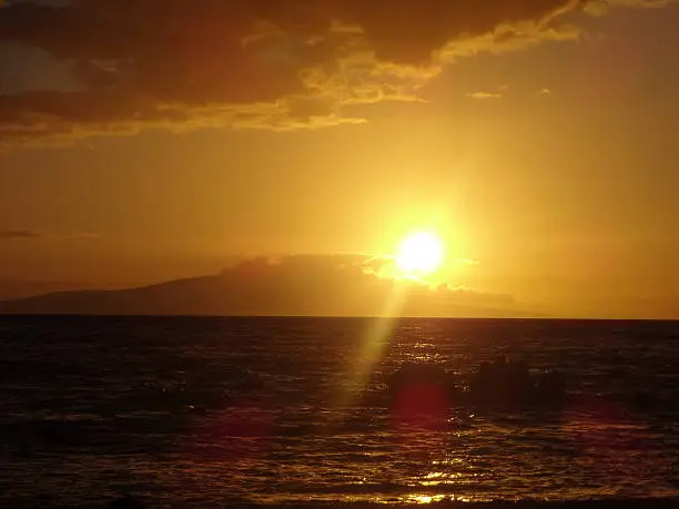 View of the sun setting off Waikiki Beach.