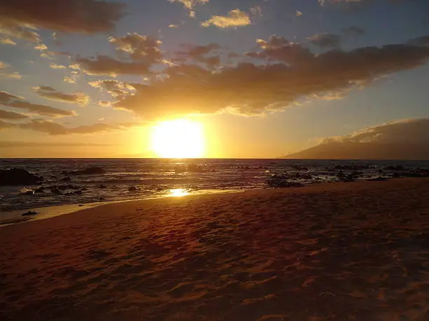 View of the sun setting off Waikiki Beach, Hawaii.