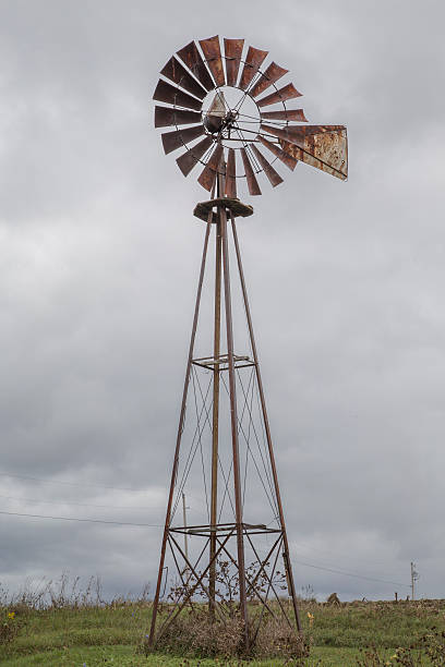 istock Sepia wind mill with gray dark rain cloud in background 481488862