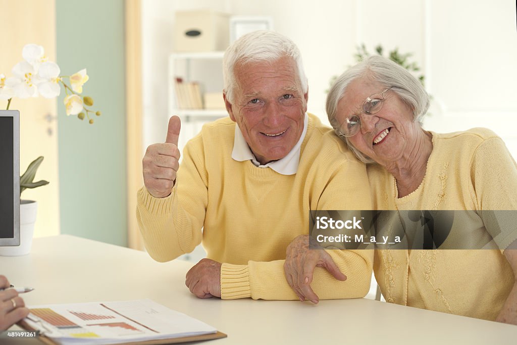 Senior couple with consultant. Elderly couple satisfied with the outcome of the talks with the consultant Achievement Stock Photo