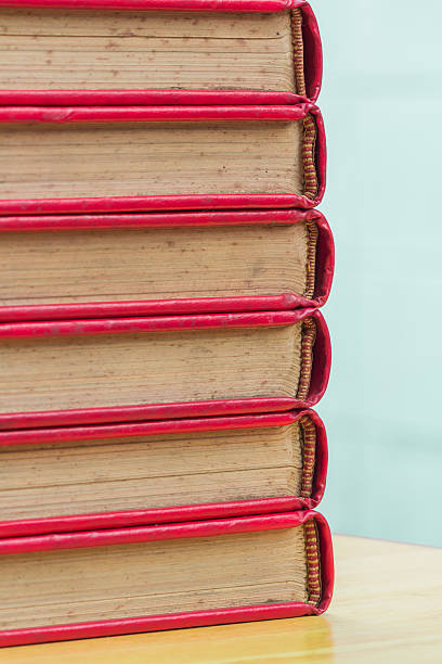 istock stack of old red cover book with blur background 481495809