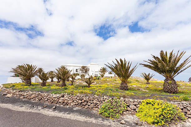 Lanzarote Spain, the Ermita de las Nieves pilgrimage chapel with palms in the foreground.