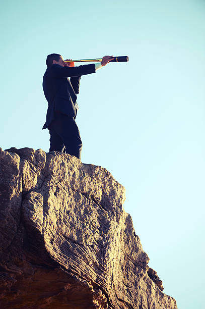 istock Businessman looking to the future with telescope 481496973