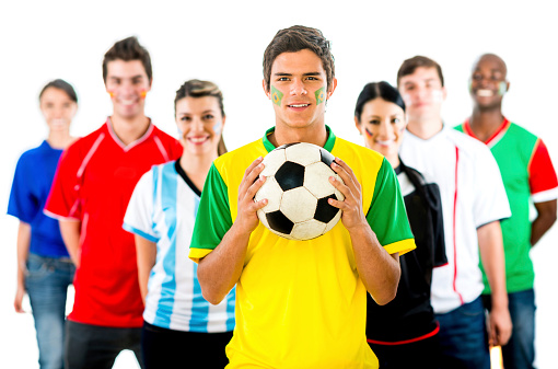 Happy group of football fans holding a ball
