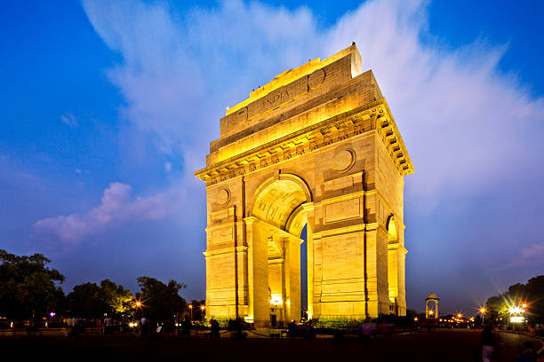 India Gate in New Dehli at dusk illuminated India Gate in Dehli at dusk ancient arch architecture brick stock pictures, royalty-free photos & images