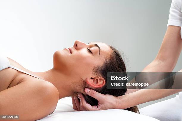 Physiotherapist Pressing Back Of Womans Head Stock Photo - Download Image Now - Osteopath, Chiropractor, Chiropractic Adjustment