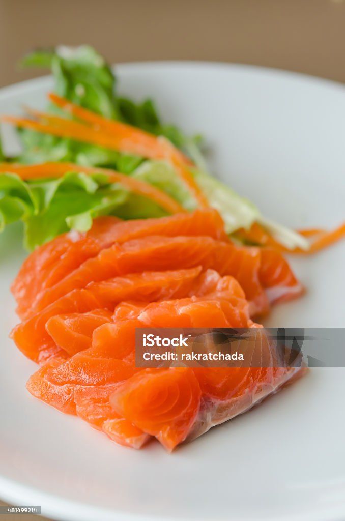 Salmon sashimi salmon sashimi with fresh salad on white dish, japanese style cuisine 2015 Stock Photo