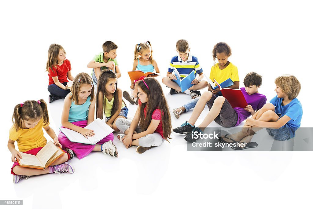 Group of children studying together. Large group of elementary students sitting and studying together. Isolated on white.   Elementary Student Stock Photo