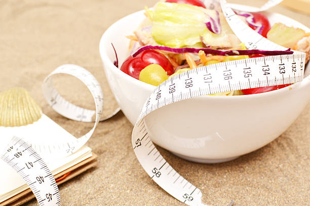 istock Salad, tape measure and shells on sand 481501384