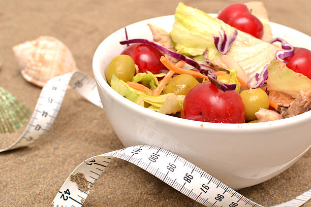 istock Salad, tape measure and shells on sand 481501464
