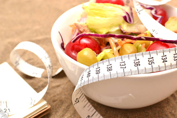 istock Salad, tape measure and shells on sand 481501556